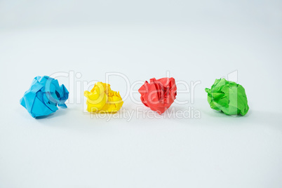 Multi-colored crumbled paper on white background