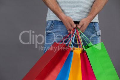 Man holding colourful shopping bags