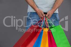 Man holding colourful shopping bags