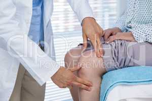 Doctor examining patient knee