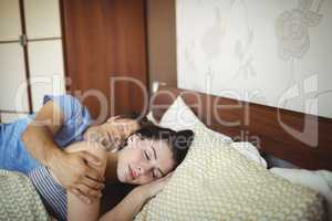 Romantic couple sleeping on bed