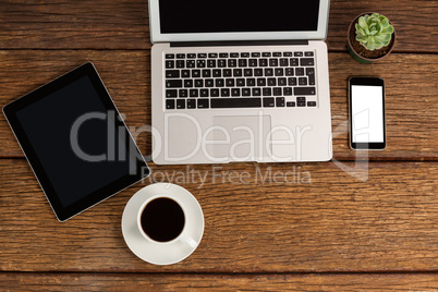Digital tablet, laptop and smartphone with cup of coffee