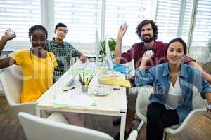 Team of business executives holding crumpled paper at desk