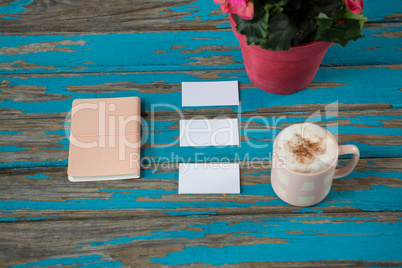 Coffee with diary and sticky notes on table