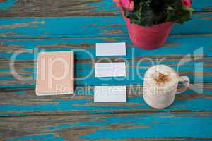 Coffee with diary and sticky notes on table