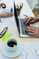 Business executive using laptop at his desk