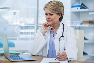 Female doctor working at her desk