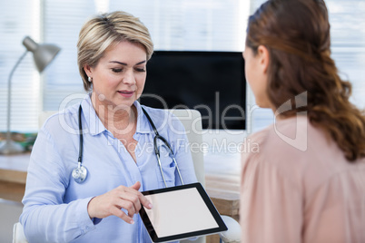 Doctor showing digital tablet to patient Doctor showing digital tablet to patient