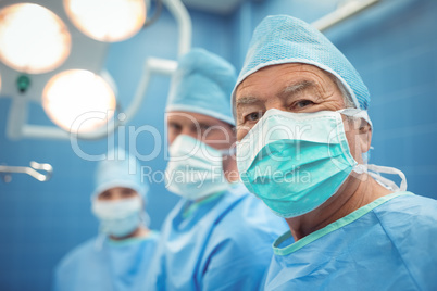 Portrait of male surgeon wearing surgical mask in operation theater