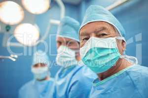 Portrait of male surgeon wearing surgical mask in operation theater