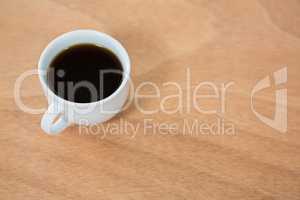 Black coffee on wooden table