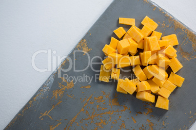 Cheddar cheese slices on cutting board