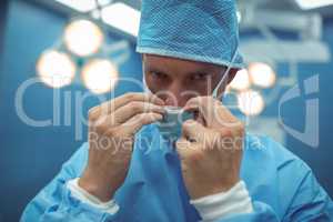 Portrait of male surgeon wearing surgical mask in operation theater