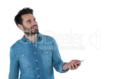 Man dreaming while holding a mobile phone