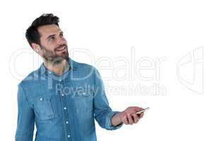Man dreaming while holding a mobile phone