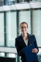 Smiling businesswoman holding a file