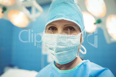 Portrait of female surgeon wearing surgical mask in operation theater