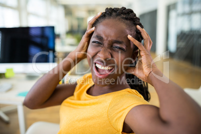 Frustrated female business executive at desk