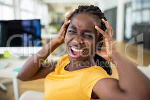 Frustrated female business executive at desk