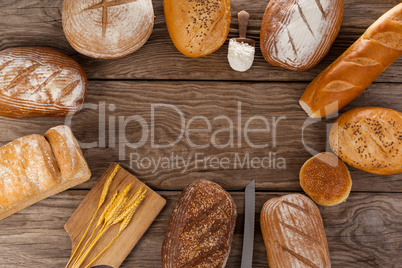 Various bread loaves with scoop of flour and wheat