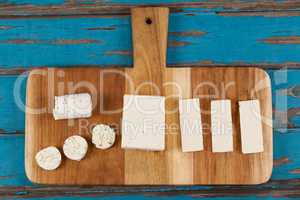 Variety of cheese arranged on chopping board