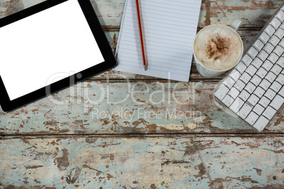 Digital tablet and keyboard with a cup of coffee