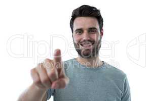 Smiling man pretending to touch an invisible screen