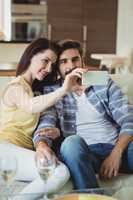 Romantic couple relaxing on sofa and taking a selfie