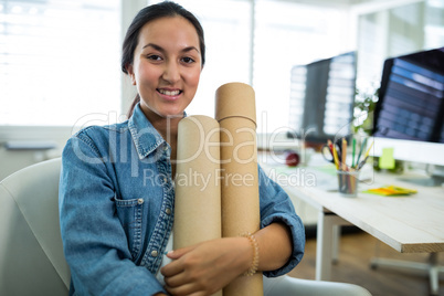Woman sitting on a chair and holding chart holder