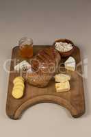 Variety of cheese with bread and sauce on chopping board