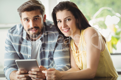 Happy couple using digital tablet