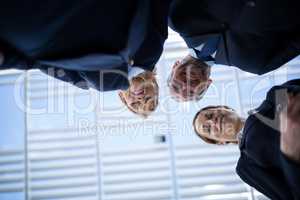 Smiling businesspeople looking down