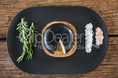 Cheese, rosemary herbs and sea salt on slate plate