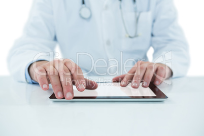 Doctor examining with stethscope against white background