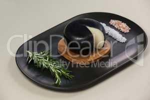 Black cheese with rosemary and salt on serving tray