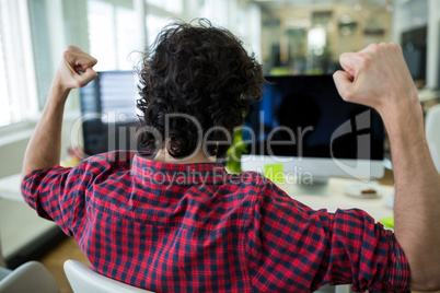 Business executive watching a football match on computer