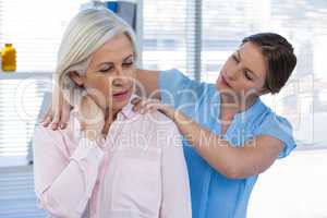 Doctor massaging a patient's shoulder