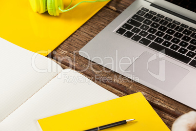 Laptop, diary, pen, coffee mug and headphones