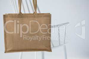 Jute bag hanging on a white chair