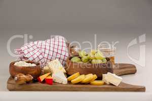 Loaf of bread with cheese, knife and jam