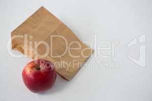 Brown paper parcel bag with red apple