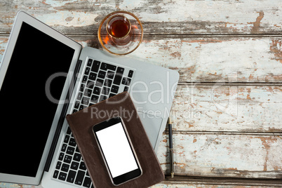 Laptop, smartphone and diary with coffee cup