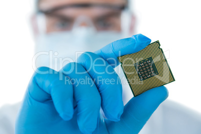 Doctor wearing medical gloves holding electronic chip