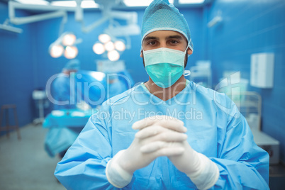 Portrait of male surgeon praying in operation theater