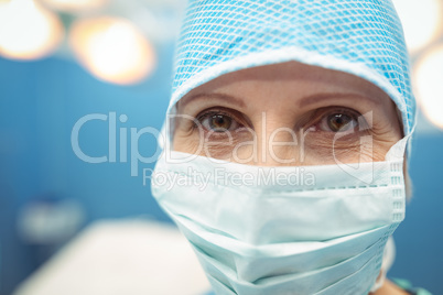 Portrait of female surgeon wearing surgical mask in operation theater