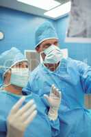 Male and female surgeons interacting in operation theater