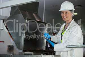 Technician examining meat processing machine