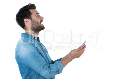 Man dreaming while holding a mobile phone