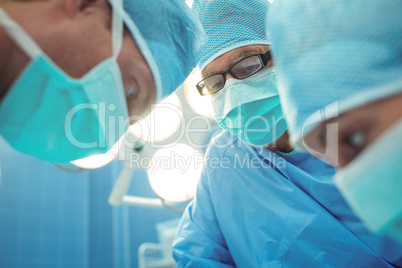 Team of surgeons performing operation in operation theater