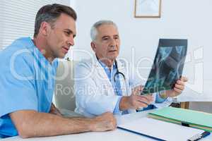 Surgeon and doctor discussing x-ray report